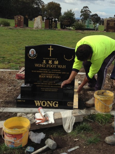 Stone mason erecting lawn headstone at Lilydale